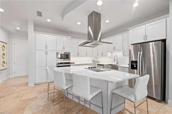 Kitchen with sink, white cabinetry, island exhaust hood, a kitchen island, and stainless steel appliances