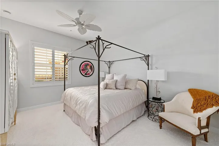 Bedroom with light carpet and ceiling fan
