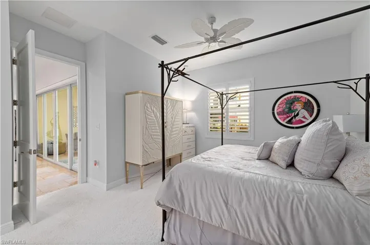 Carpeted bedroom featuring ceiling fan