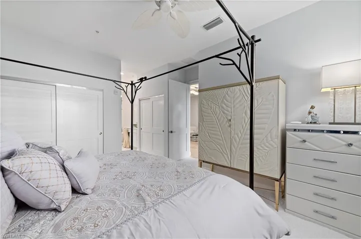 Carpeted bedroom with ceiling fan