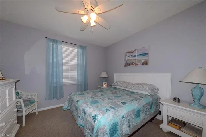 Bedroom with ceiling fan and carpet floors