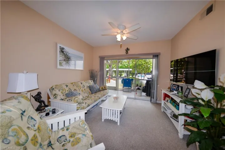 Living room with ceiling fan and carpet flooring