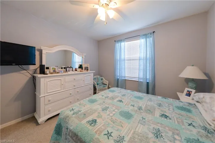 Bedroom featuring ceiling fan and light carpet