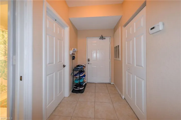 Doorway featuring light tile patterned flooring