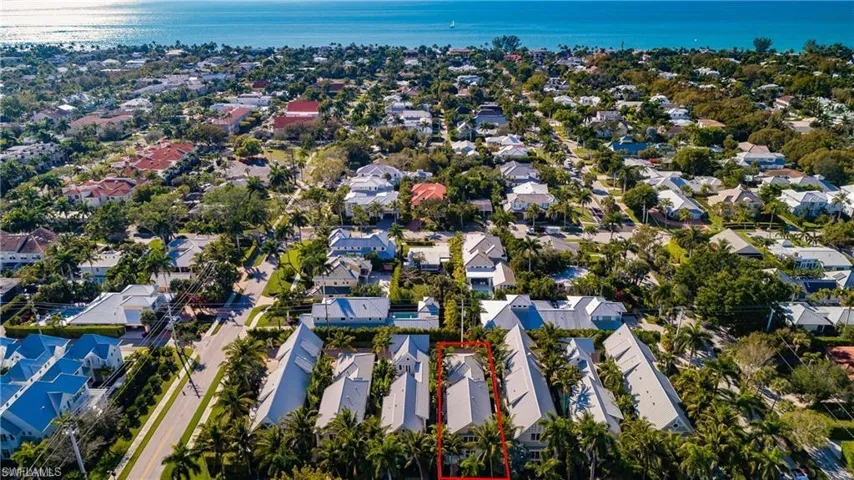 Aerial perspective of suburban area with a large body of water