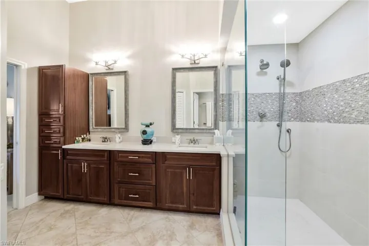 Primary Raised Wood Cabinetry, Cambria Quartz, Custom Lighting, Mirrors, Fixtures, Tile Floor Huge Closet System/Walk In Closet not shown
