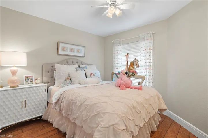 Bedroom featuring hardwood / wood-style floors and ceiling fan