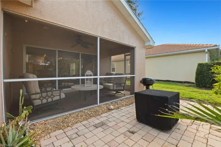 View of patio with a sunroom