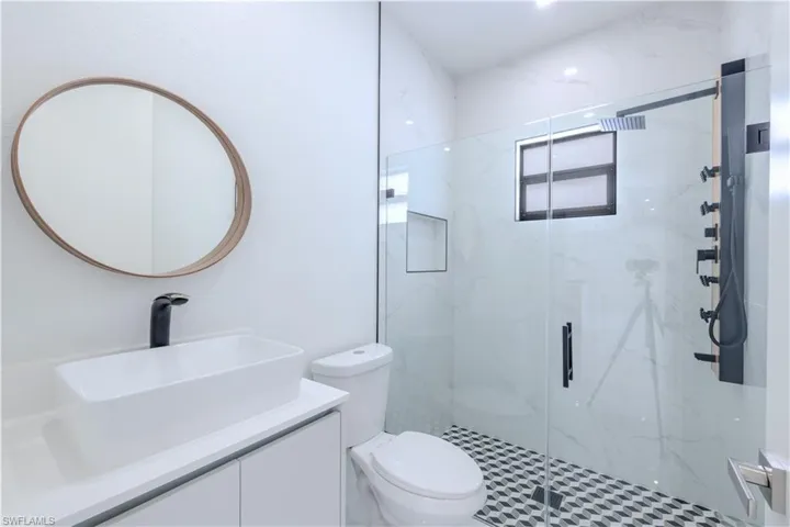 Full bathroom with vanity and a marble finish shower