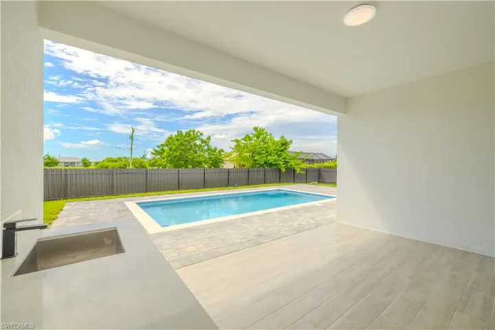 View of pool with a patio and a fenced backyard