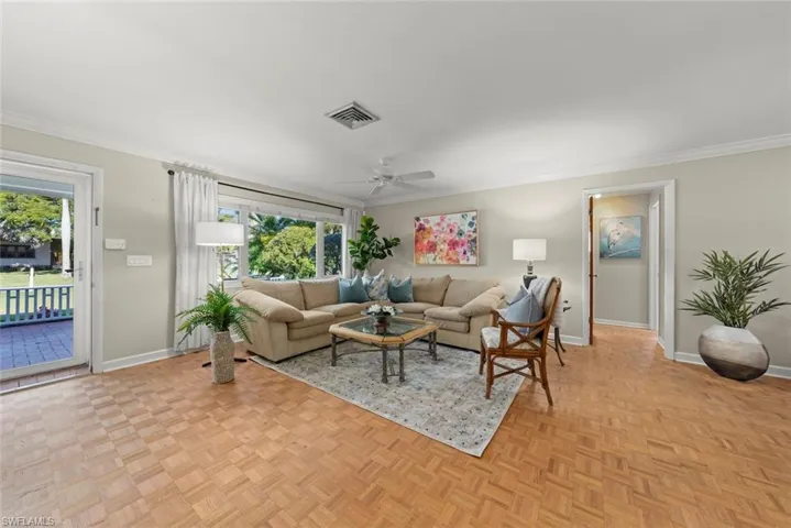 Living room featuring parquet floors and crown molding