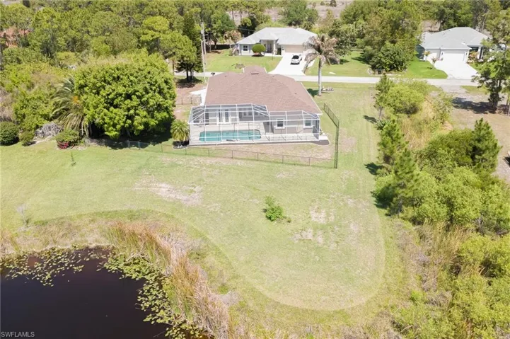 View of subject property featuring a pool