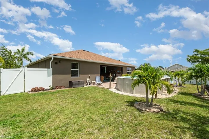 Rear view of property featuring a patio and a lawn