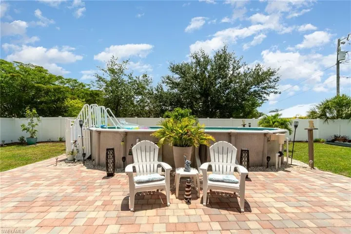 View of terrace featuring a swimming pool with hot tub