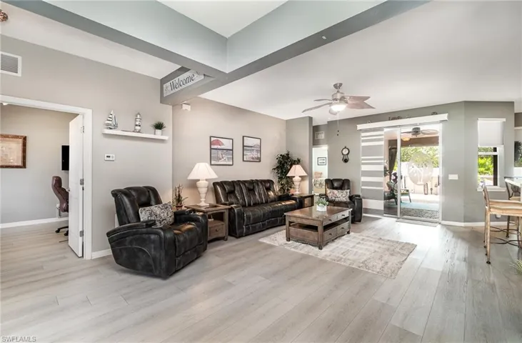 Living room with light hardwood / wood-style floors and ceiling fan