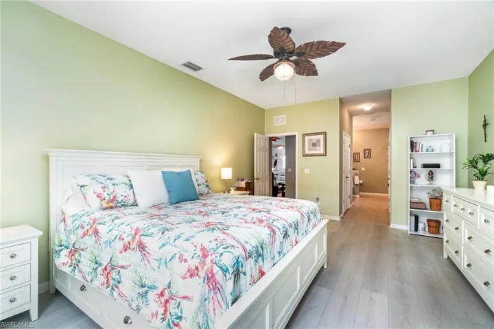 Bedroom with ceiling fan and light hardwood / wood-style floors