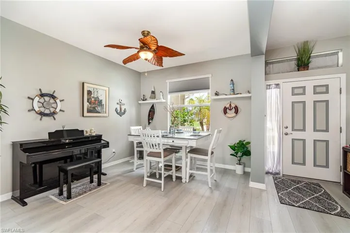 Dining space with ceiling fan and light wood-type flooring