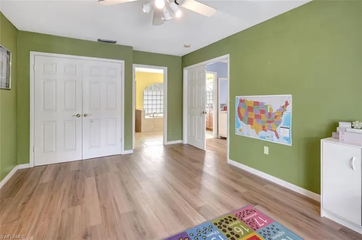 Unfurnished bedroom with ceiling fan, a closet, and light hardwood / wood-style flooring