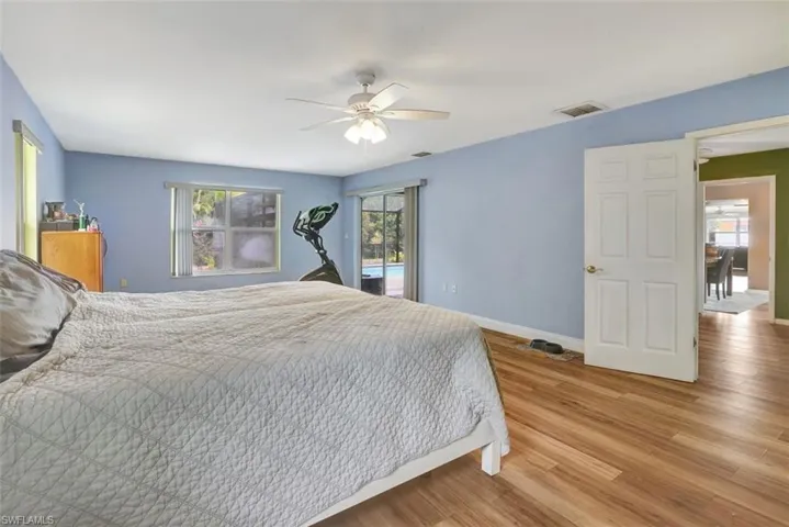 Bedroom featuring ceiling fan, access to exterior, and light wood-type flooring