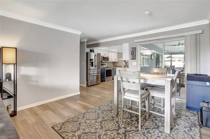 Dining space featuring crown molding and light hardwood / wood-style floors