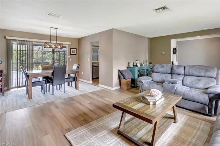 Living room with light hardwood / wood-style flooring and a chandelier