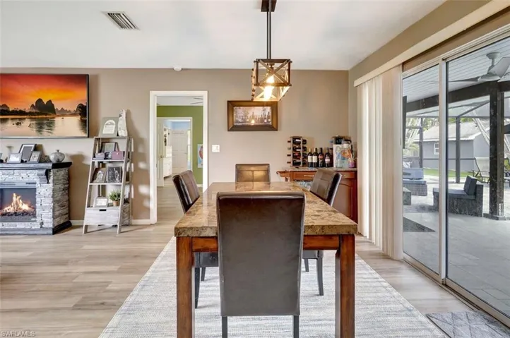 Dining room featuring light hardwood / wood-style floors and a fireplace