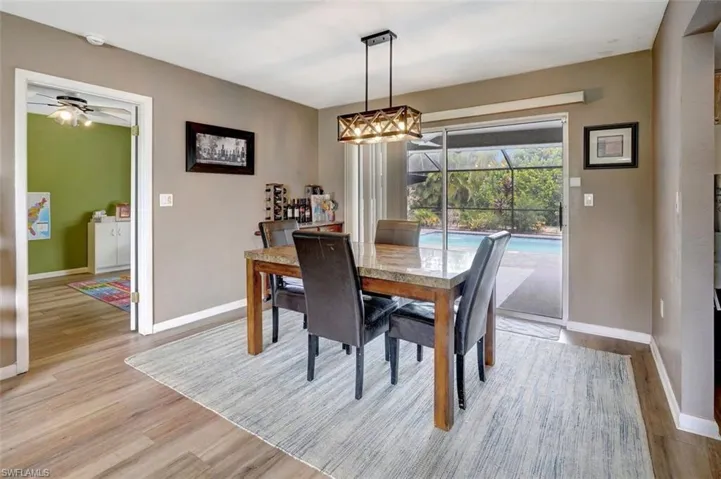 Dining area with ceiling fan and light hardwood / wood-style floors