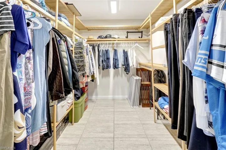 Walk in closet with light tile patterned floors