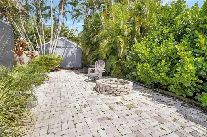 View of patio / terrace featuring a storage unit and a fire pit