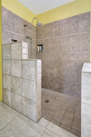 Bathroom featuring tiled shower