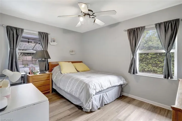 Bedroom with hardwood / wood-style floors and ceiling fan