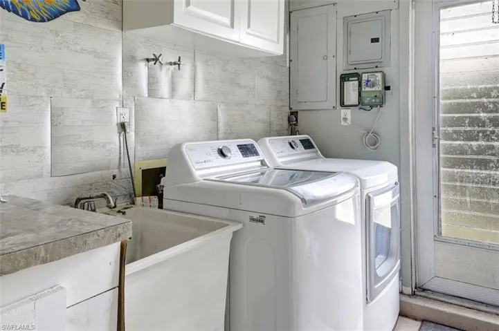 Laundry room with washer and dryer and cabinets