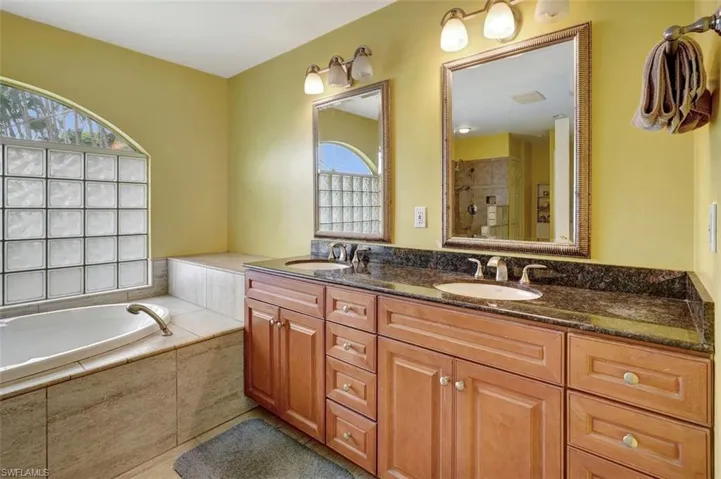 Bathroom featuring independent shower and bath and vanity