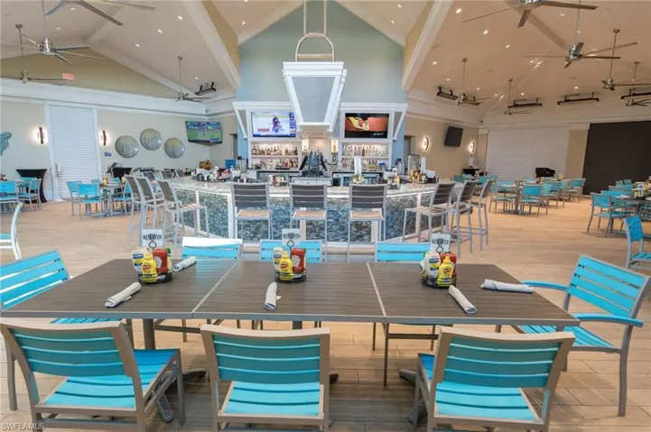 Dining room with a ceiling fan and high vaulted ceiling