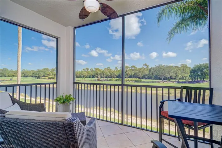 Sunroom featuring a water view and ceiling fan