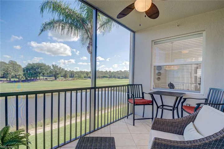 Sunroom with ceiling fan, a healthy amount of sunlight, and golf course view