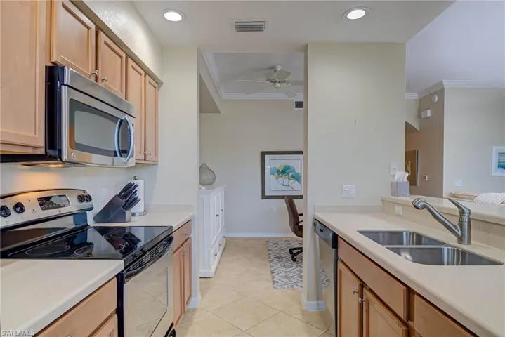 Kitchen featuring visible vents, ceiling fan, light countertops, a sink, and stainless steel appliances
