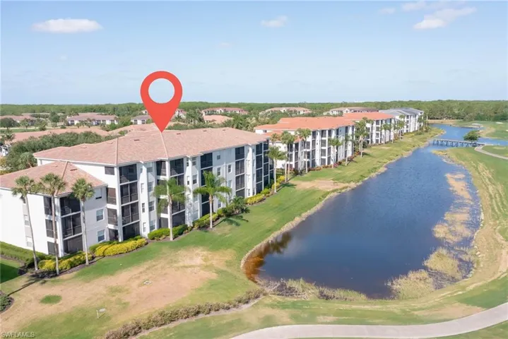 Bird's eye view featuring a water view and view of golf course