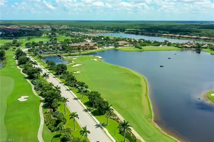 Drone / aerial view featuring a water view, view of golf course, and a residential view
