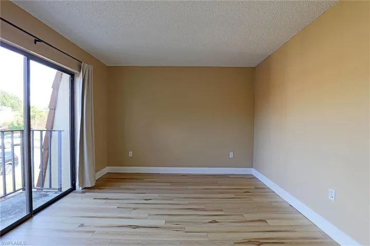 Spare room featuring light wood finished floors and a textured ceiling