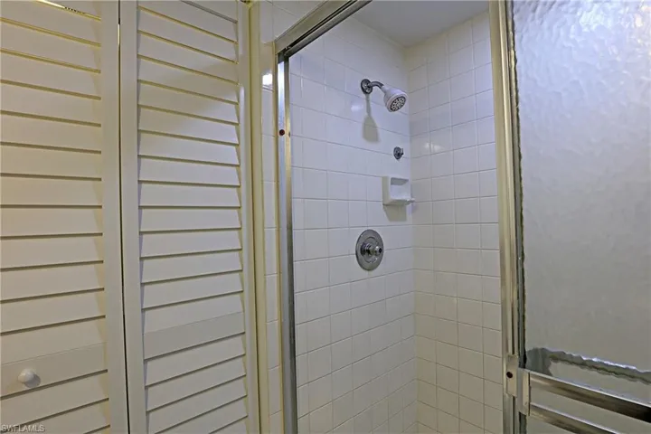 Bathroom with a stall shower and a towel warming rack