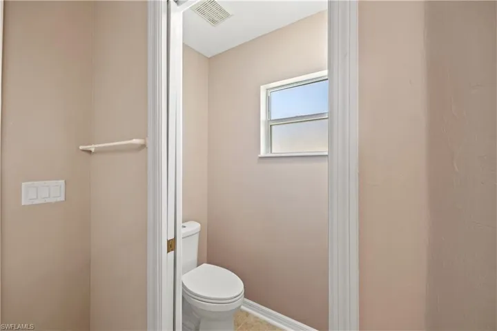 Bathroom featuring toilet and tile patterned flooring