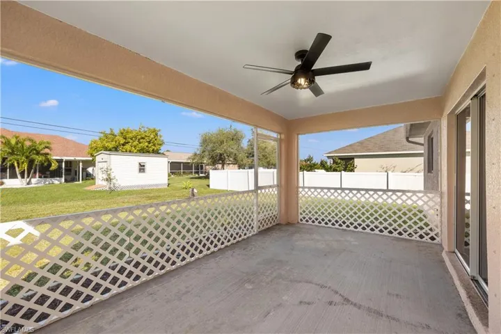 View of patio with a storage shed and ceiling fan