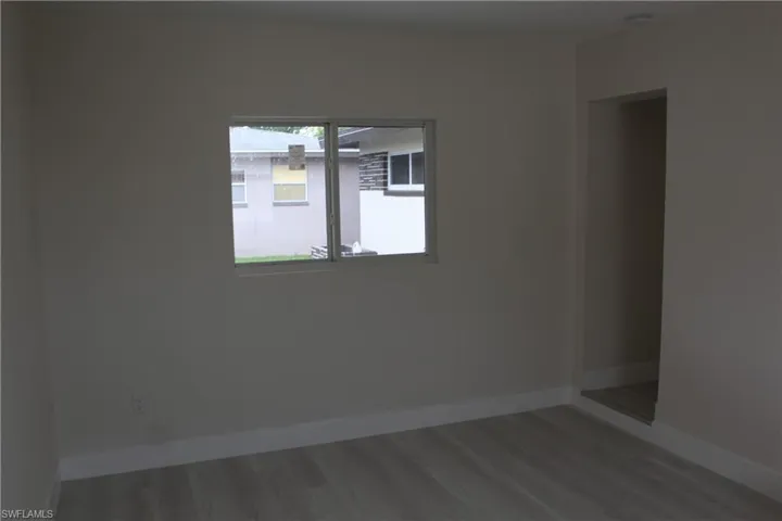 Empty room with baseboards and wood finished floors