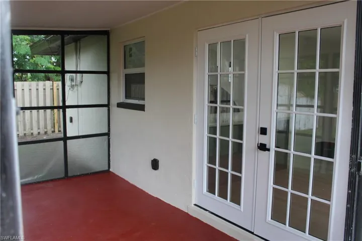Unfurnished sunroom with french doors