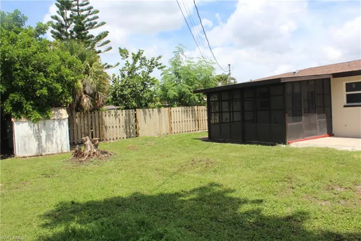 View of yard with a sunroom