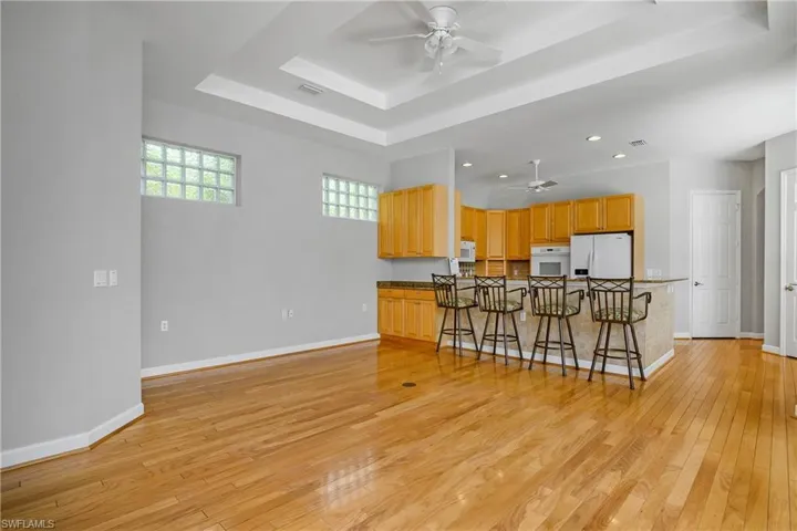 Spacious family room includes oversized sliders, tray ceiling, kitchen island/breakfast bar, and additional beverage service area.