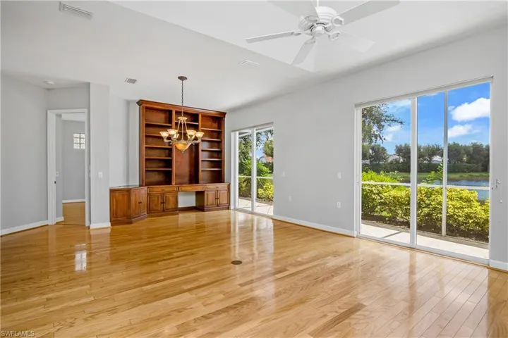 Dining area with sliding doors allowing plenty of natural light, light hardwood / wood-style flooring, and custom bookshelves.