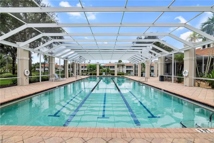 Lap pool with a patio and screened enclosure.