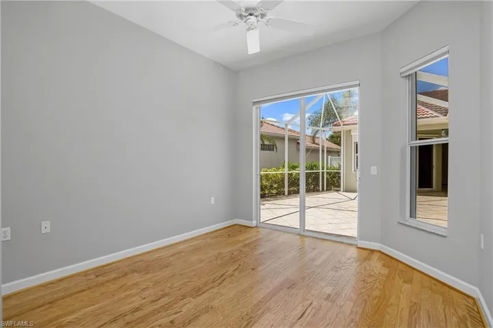 Guest bedroom overlooks courtyard and includes sliding doors with outdoor access.